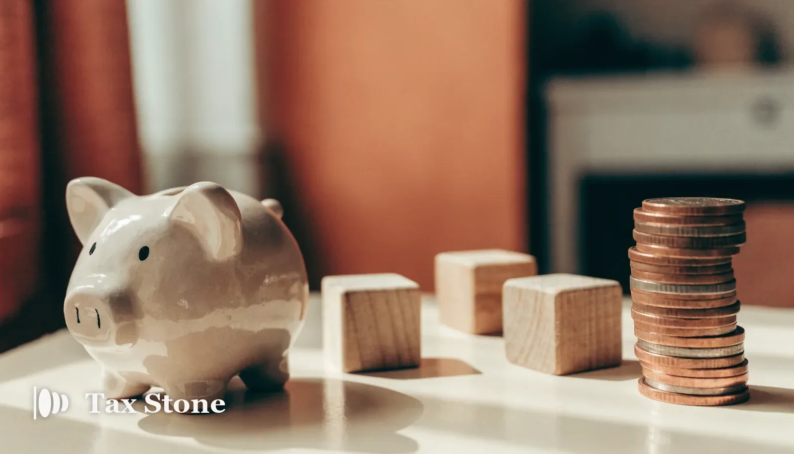 Piggy bank, wooden toy blocks and a stack of US dollar coins — TaxStone US Child Tax Credit calculator