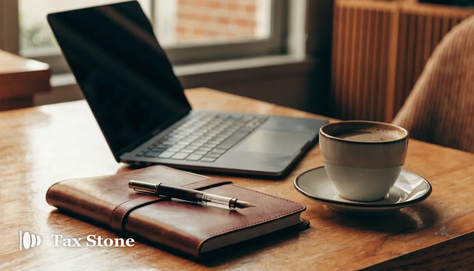 Self-employed home office desk with laptop, leather notebook and coffee — TaxStone US self-employment tax calculator for 1099 and freelance income